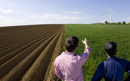 People in front of a wind turbine